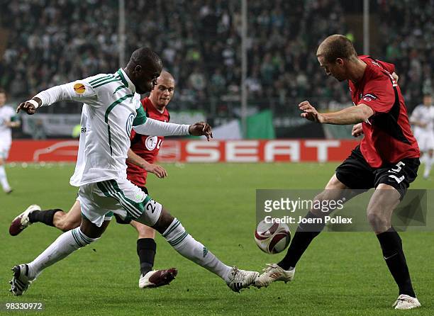 Grafite of Wolfsburg and Brede Hangeland of Fulham compete for the ball during the UEFA Europa League quarter final second leg match between VfL...