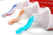 Tubes of toothpaste in different colors and different types of toothpaste