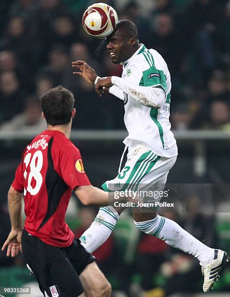 Grafite of Wolfsburg and Aaron Hughes of Fulham compete for the ball during the UEFA Europa League quarter final second leg match between VfL...