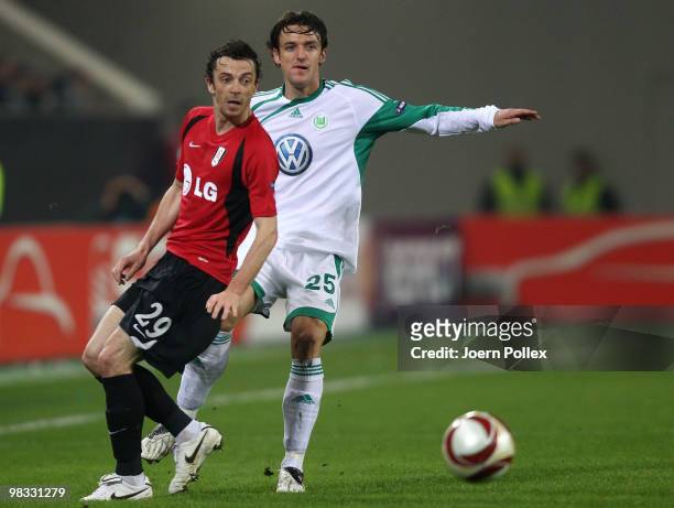 Christian Gentner of Wolfsburg and Simon Davies of Fulham compete for the ball during the UEFA Europa League quarter final second leg match between...