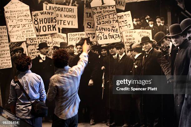 People look at historic images of immigrants at a museum on Ellis Island on April 8, 2010 in New York, New York. The nonprofit in charge of restoring...