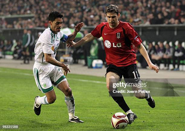 Josue of Wolfsburg and Zoltan Gera of Fulham compete for the ball during the UEFA Europa League quarter final second leg match between VfL Wolfsburg...