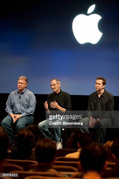 Steve Jobs, chief executive officer of Apple Inc., center, is flanked by Philip Schiller, senior vice president of Apple's worldwide product...