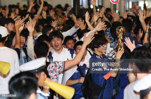 Japanese supporters cheer after the 2018 FIFA World Cup match against Senegal at Shibuya Crossing on June 25, 2018 in Tokyo, Japan.