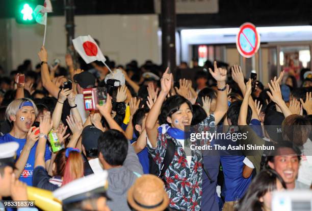Japanese supporters cheer after the 2018 FIFA World Cup match against Senegal at Shibuya Crossing on June 25, 2018 in Tokyo, Japan.