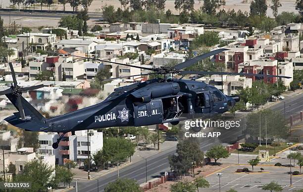 Helicopter of the Mexican police overflies Ciudad Juarez, on April 8, 2010. Ciudad Juarez, with 1.3 million inhabitants, is the most violent city in...