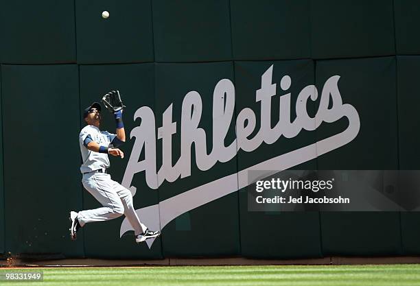 Franklin Gutierrez of the Seattle Mariners catches a ball hit by Kevin Kouzmanoff of the Oakland Athletics during an MLB game at the Oakland-Alameda...