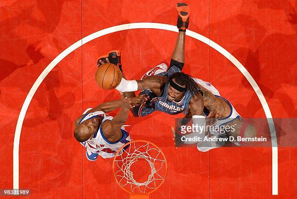 Gerald Wallace of the Charlotte Bobcats goes to the basket against Travis Outlaw and Drew Gooden of the Los Angeles Clippers during the game on...
