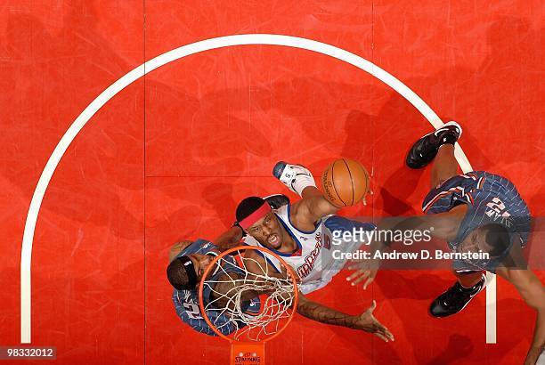 Craig Smith of the Los Angeles Clippers goes to the basket over Tyrus Thomas and Boris Diaw of the Charlotte Bobcats during the game on February 22,...