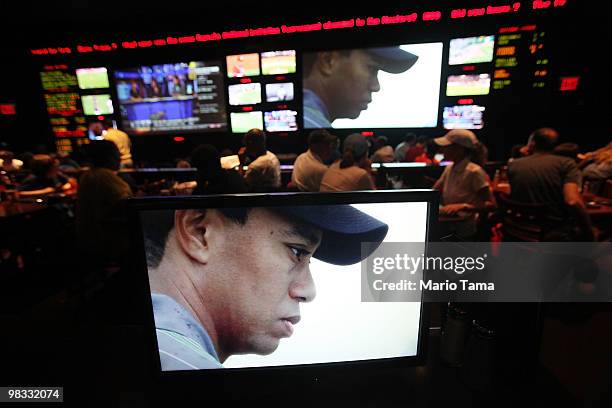 Sports fans watch Tiger Woods play during Masters coverage televised at ESPN Zone April 8, 2010 in New York City. Woods is playing in the Masters for...