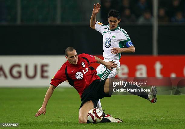Josue of Wolfsburg and Bobby Zamora of Fulham compete for the ball during the UEFA Europa League quarter final second leg match between VfL Wolfsburg...