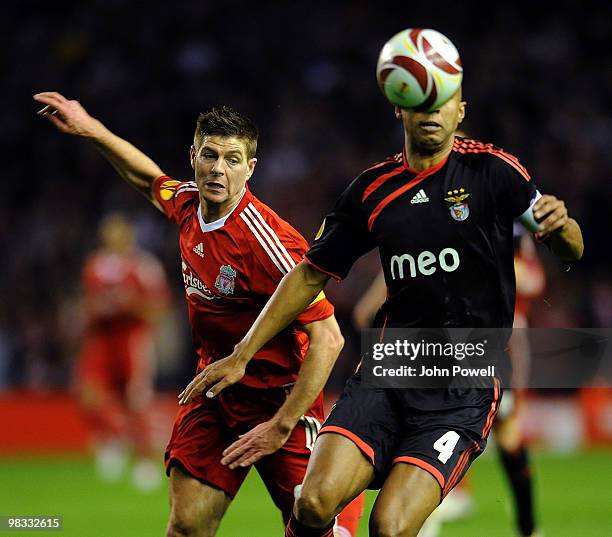 Steven Gerrard of Liverpool competes with Luisao of Benfica during the quarter final second leg UEFA Europa League match between Liverpool and...