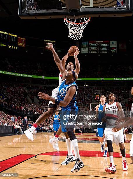 Marcus Camby of the Portland Trail Blazers goes up for a shot against Erick Dampier of the Dallas Mavericks during the game at The Rose Garden on...