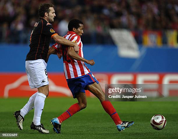 Paulo Assuncao of Atletico Madrid in action with Ruben Baraja of Valencia during the UEFA Europa League quarter final second leg match between...