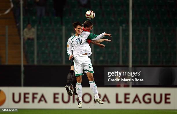 Christian Gentner of Wolfsburg and Christopher Baird of Fulham compete for the ball during the UEFA Europa League quarter final second leg match...