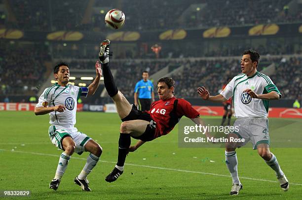 Josue , Marcel Schaefer of Wolfsburg and Zoltan Gera of Fulham compete for the ball during the UEFA Europa League quarter final second leg match...