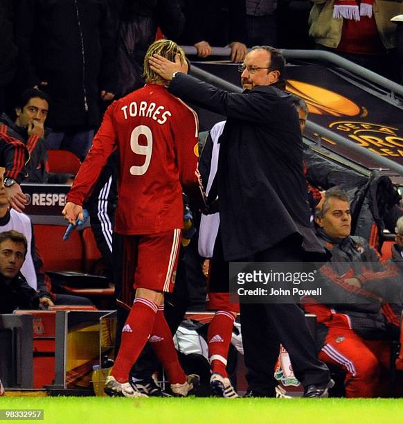 Rafael Benitez manager of Liverpool pats Fernando Torres of Liverpool on the back of the head during the quarter final second leg UEFA Europa League...