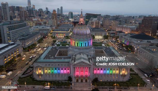 An aerial photo shows San Francisco City Hall lit up in rainbow colors following the Pride parade in San Francisco, California on Sunday, June 24,...