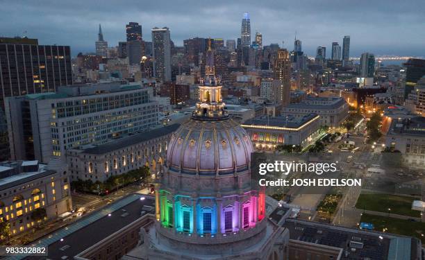 An aerial photo shows San Francisco City Hall lit up in rainbow colors following the Pride parade in San Francisco, California on Sunday, June 24,...