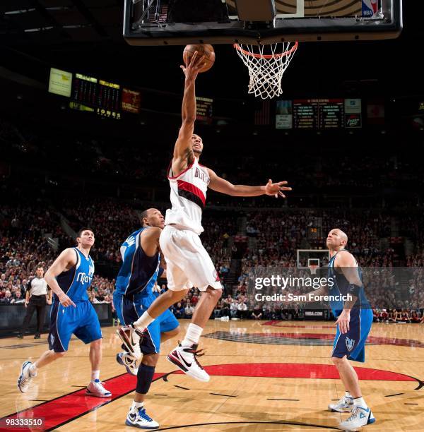 Brandon Roy of the Portland Trail Blazers shoots a layup against Shawn Marion and Jason Kidd of the Dallas Mavericks during the game at The Rose...