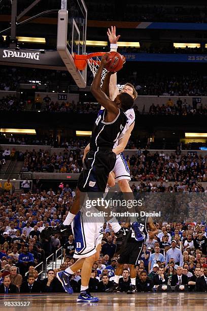 Shelvin Mack of the Butler Bulldogs has his shot attempt blocked in the first half by Kyle Singler of the Duke Blue Devils during the 2010 NCAA...