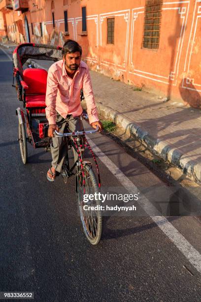 indian men ride cycle rickshaw, india - rickshaw driver stock pictures, royalty-free photos & images