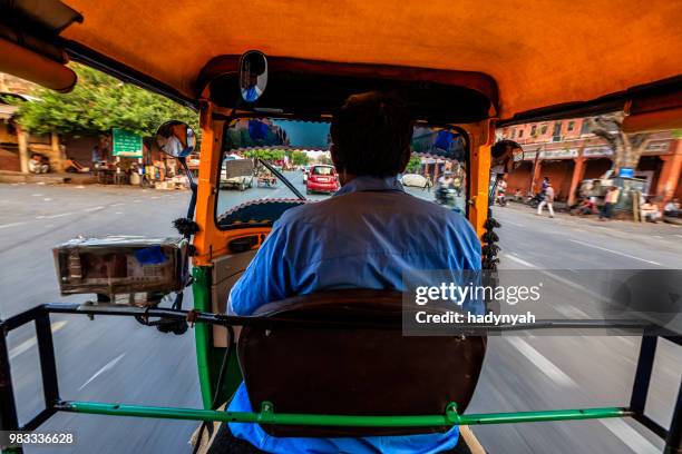 indian man drives auto rickshaw (tuk-tuk), india - jinrikisha stock pictures, royalty-free photos & images