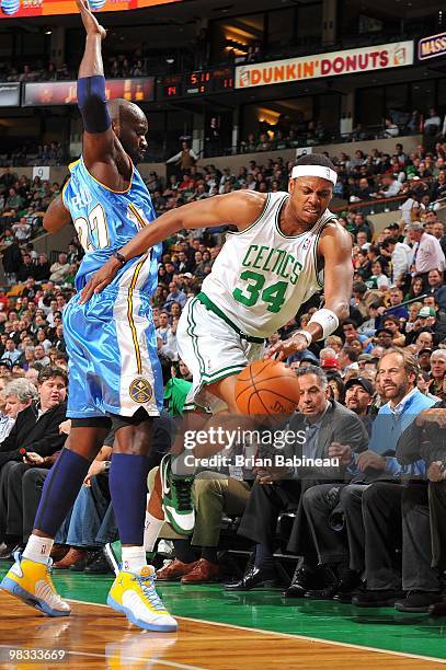 Paul Pierce of the Boston Celtics is forced out of bounds against Johan Petro of the Denver Nuggets during the game at The TD Garden on March 24,...