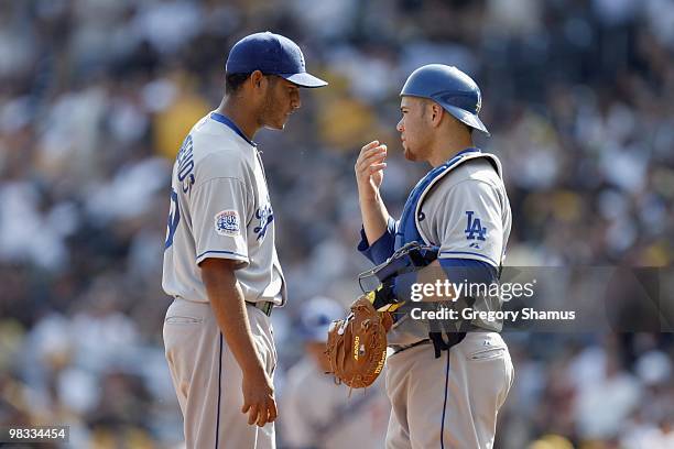 Pitcher Carlos Monasterios of the Los Angeles Dodgers listens to catcher Russell Martin during season home opener game against the Pittsburgh Pirates...