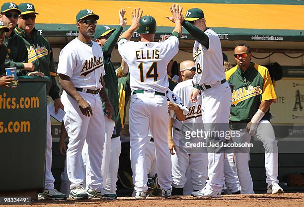 Mark Ellis of the Oakland Athletics celebrates after scoring on an Daric Barton single in the 4th inning against the Seattle Mariners during an MLB...