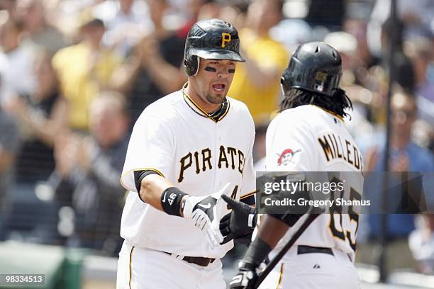 Garrett Jones of the Pittsburgh Pirates greets Lastings Milledge against the Los Angeles Dodgers during the Home Opener for the Pittsburgh Pirates on...