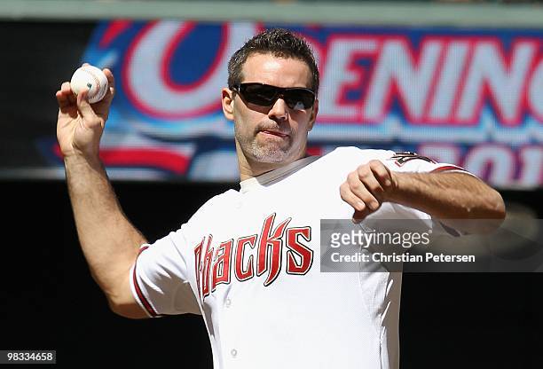 Former Arizona Cardinals quarterback Kurt Warner throws out the ceremonial first pitch before the Opening Day major league baseball game between the...