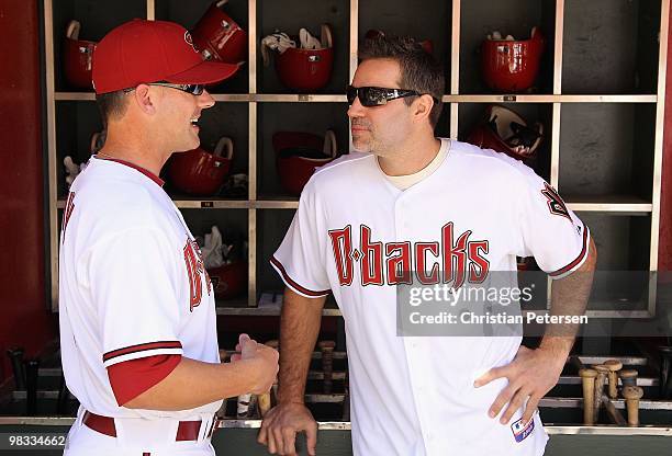 Manager A.J. Hinch of the Arizona Diamondbacks talks with former Arizona Cardinals quarterback Kurt Warner before he throws out the ceremonial first...