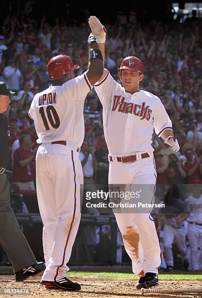 Stephen Drew of the Arizona Diamondbacks is congratulated by teammate Justin Upton after hitting a 2 run inside the park home run against the San...