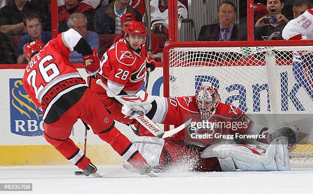 Cam Ward of the Carolina Hurricanes makes a save with the help of teammate Erik Cole during a NHL game against the Montreal Canadiens on April 8,...