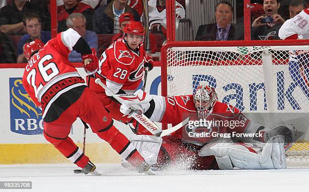 Cam Ward of the Carolina Hurricanes makes a save with the help of teammate Erik Cole during a NHL game against the Montreal Canadiens on April 8,...