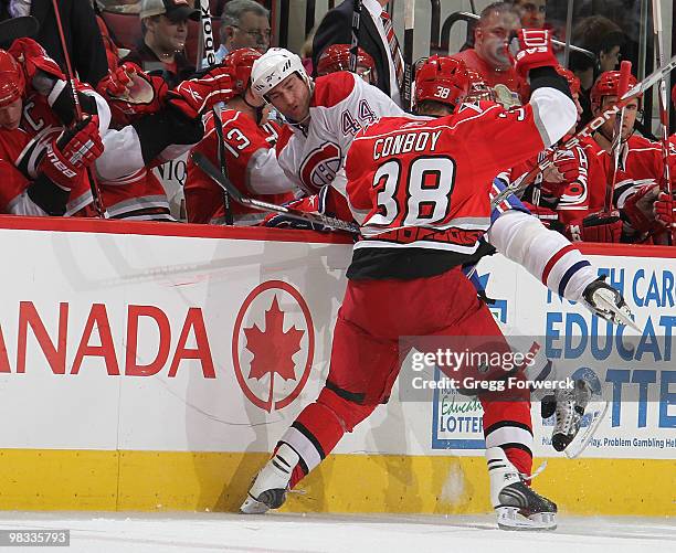 Tim Conboy of the Carolina Hurricanes collides along the bench with Roman Hamrlik of the Montreal Canadiens during a NHL game on April 8, 2010 at RBC...