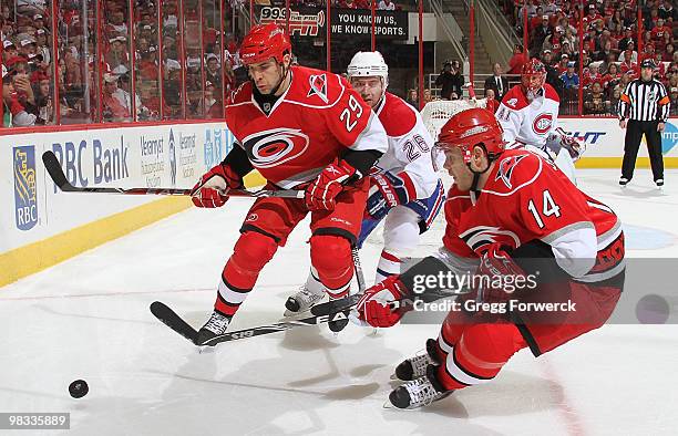 Tom Kostopoulos and Sergei Samsonov of the Carolina Hurricanes skate in front of the defense of Josh Gorges of the Montreal Canadiens during a NHL...