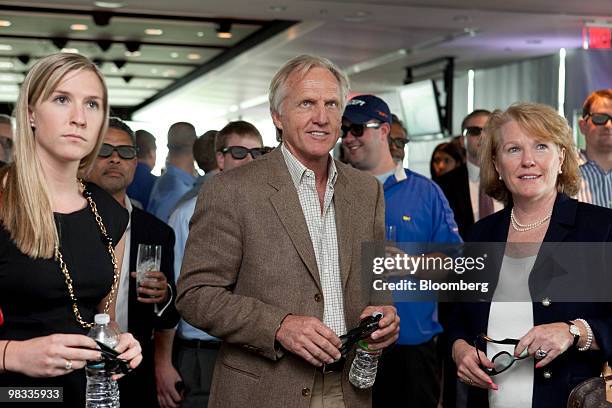 Professional golfer Greg Norman, center, watches a television at a special 3-D viewing event of the Masters golf tournament at the Newseum in...