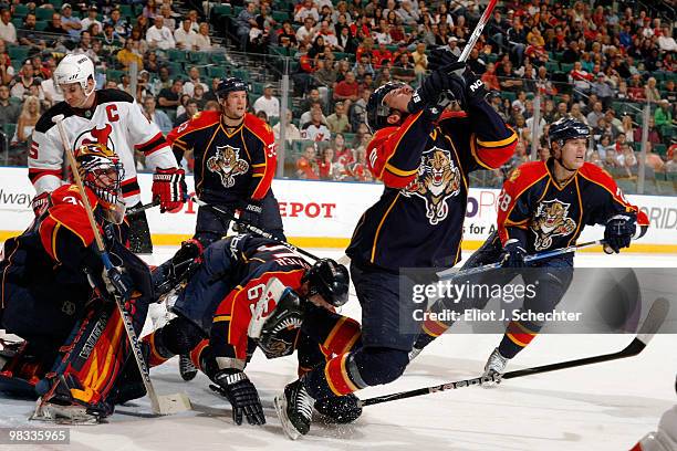 Keith Ballard of the Florida Panthers is tripped up during action against the New Jersey Devils at the BankAtlantic Center on April 8, 2010 in...