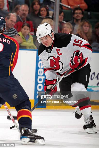 Jamie Langenbrunner of the New Jersey Devils passes the puck against Keith Ballard of the Florida Panthers at the BankAtlantic Center on April 8,...