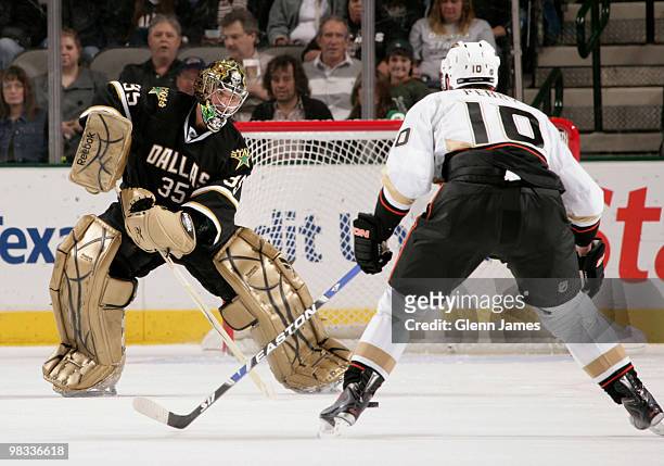 Marty Turco of the Dallas Stars makes a play on the puck against Corey Perry of the Anaheim Ducks on April 8, 2010 at the American Airlines Center in...
