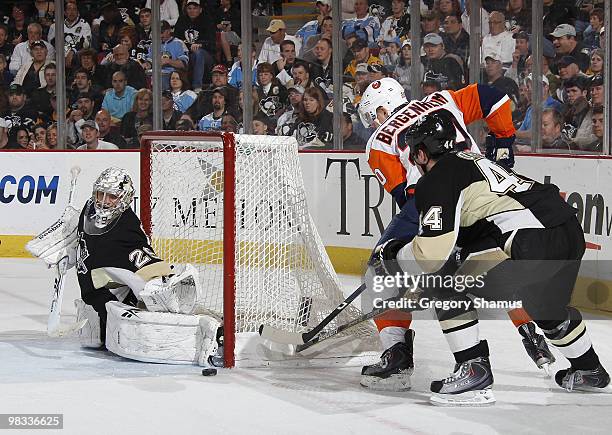 Marc-Andre Fleury of the Pittsburgh Penguins makes a save on a shot by Sean Bergenheim of the New York Islanders and Brooks Orpik on April 8, 2010 at...