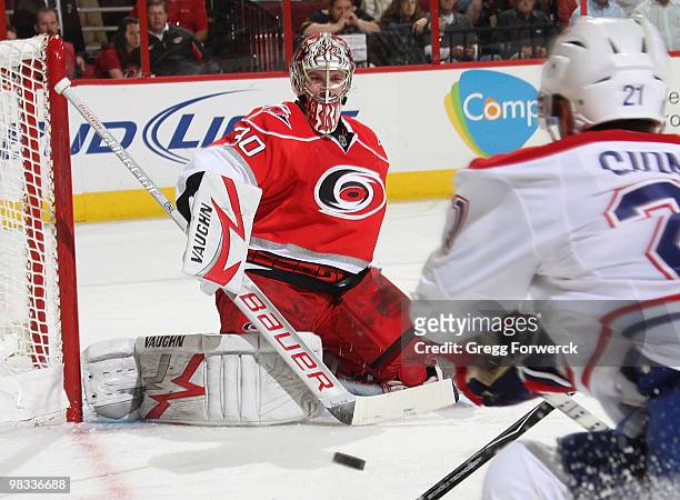 Cam Ward of the Carolina Hurricanes squares up to a shot from Brian Gionta of the Montreal Canadiens during a NHL game on April 8, 2010 at RBC Center...