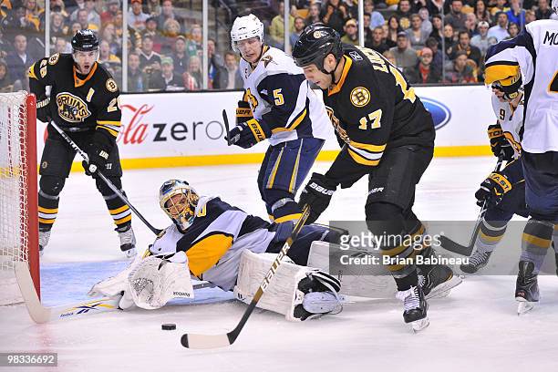 Milan Lucic of the Boston Bruins with the puck against Patrick Lalime of the Buffalo Sabres at the TD Garden on April 8, 2010 in Boston,...