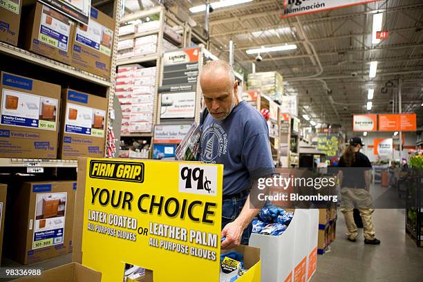 Shopper looks for sale items in a bin at a Home Depot store in the Brooklyn borough of New York, U.S., on Thursday, April 8, 2010. Home Depot Inc.,...