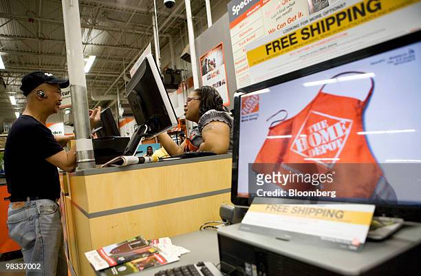 Customer service employee helps a shopper at a Home Depot store in the Brooklyn borough of New York, U.S., on Thursday, April 8, 2010. Home Depot...