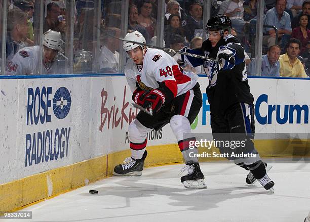 Jared Cowen of the Ottawa Senators clears the puck against Brandon Bochenski of the Tampa Bay Lightning at the St. Pete Times Forum on April 8, 2010...