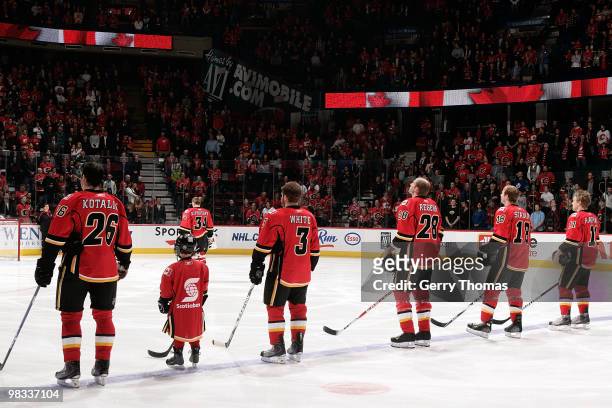 Ales Kotalik, Ian White, Robyn Regehr, Matt Stajan and Niklas Hagman of the Calgary Flames stand for the national anthem ceremony before their last...