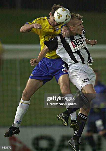 Alex Tobin of the Power heads the ball away from an Adelaide striker during the round 28 NSL match between the Parramatta Power and the Adelaide City...